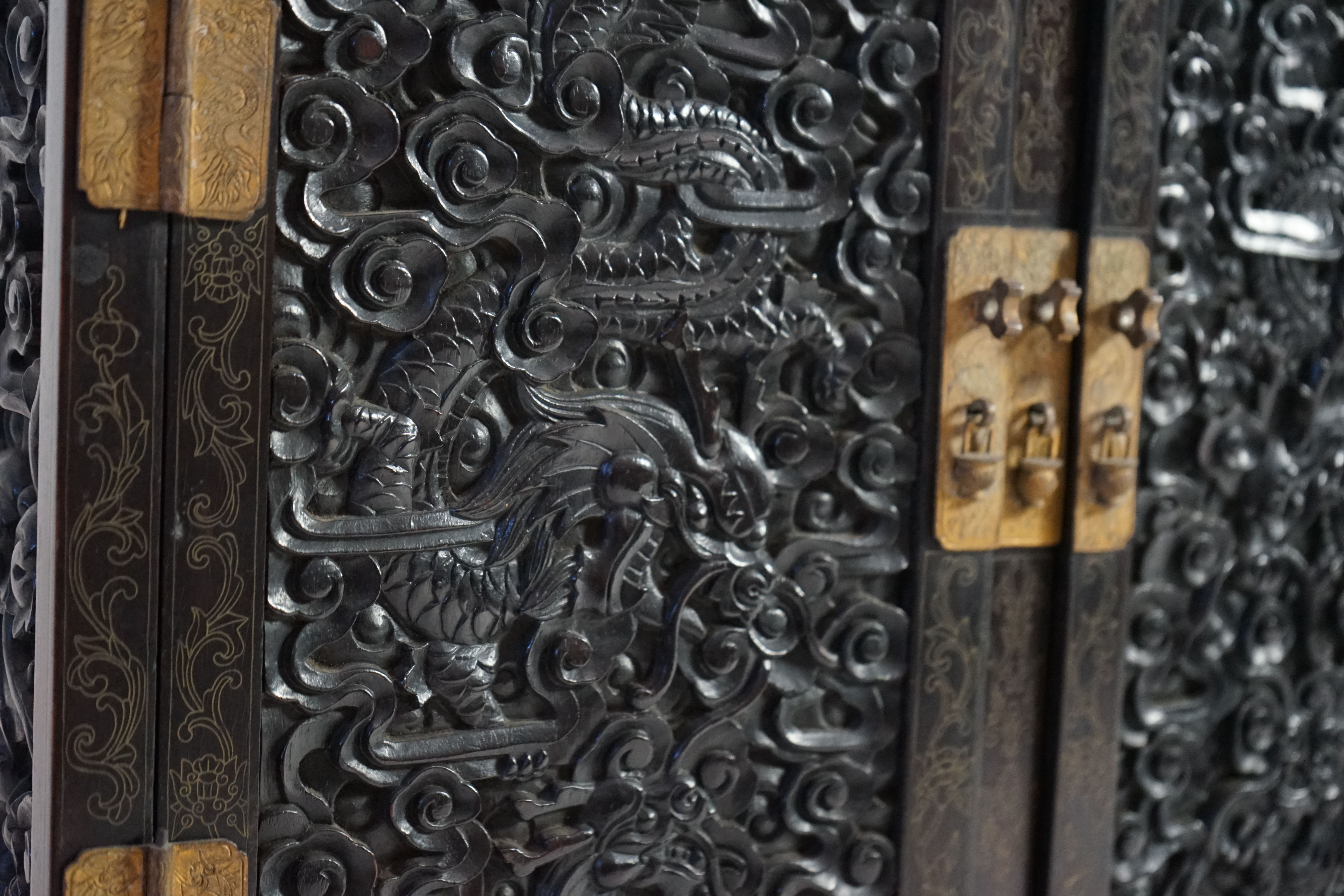 An important pair of Chinese carved zitan and silver wire inlaid ‘cloud and dragon’ curio cabinets and stands, duobaoge, probably Imperial, late Qing dynasty